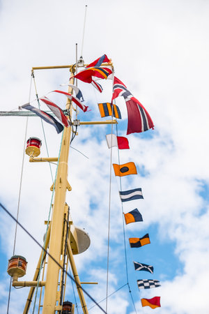 Signal flag flying from a yellow ship mast