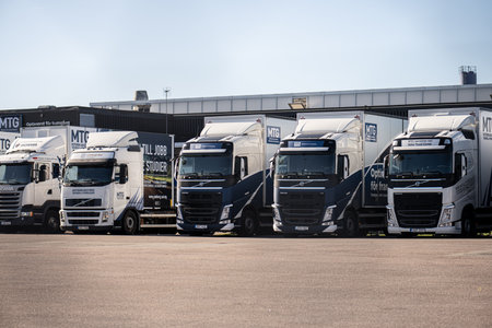 Gothenburg, Sweden - March 02 2023: Row of trucks at a schoolのeditorial素材