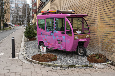Gothenburg, Sweden - February 25 2023: Pink tuktuk parked by the side of a buildingのeditorial素材