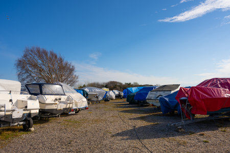 Laid up boats on land at a marina.
