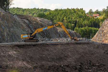 Kristiansand, Norway - August 01 2021: Large Cat excavator used at highway construction.のeditorial素材