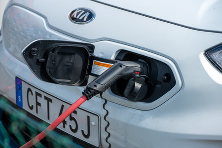 Gothenburg, Sweden - June 25 2022: White KIA car charging at an electric AC charger.のeditorial素材