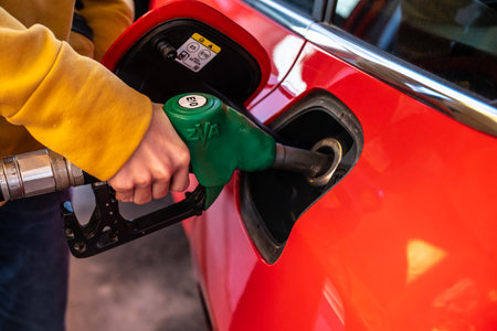 Tanum, Sweden - April 07 2023: Filling E10 gasoline on a red carのeditorial素材