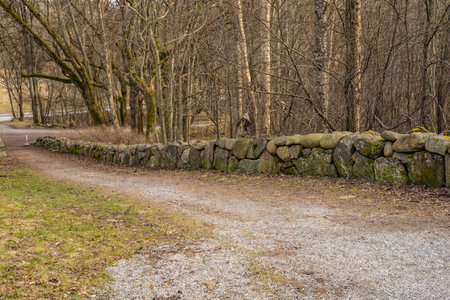 Low stone wall by a roadの写真素材