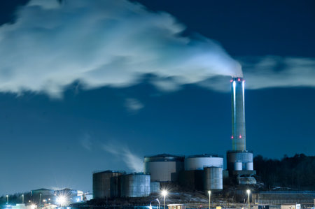 Long exposure photo of steam drifting from industrial funnels