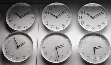 Several clocks on a wall