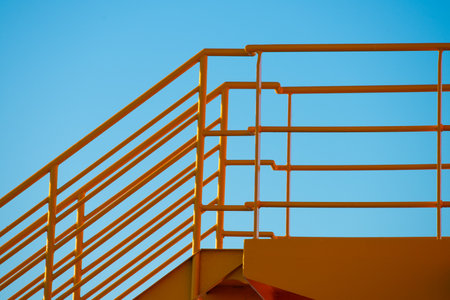 Yellow metal hand railings on a ferryの写真素材