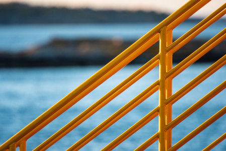 Yellow metal hand railings on a ferryの写真素材