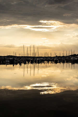 Golden sunset over a large marina in springの写真素材