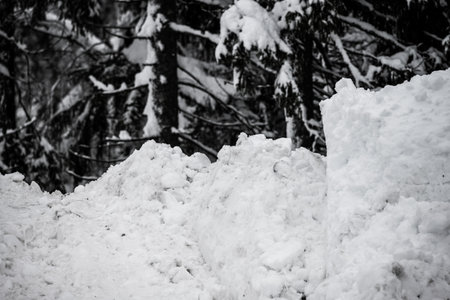 Big pile of dirty snow plowed off a parking lotの写真素材