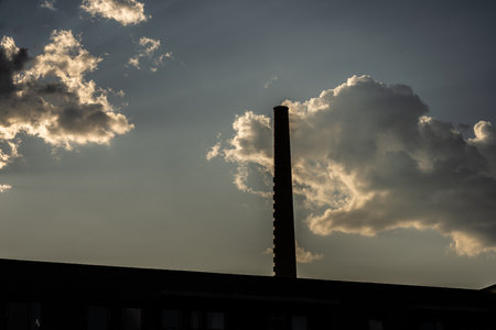 Tall chomney against clouds on a blue sky