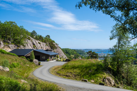 Lindesnes, Norway - June 24 2023: Modern house placed high up on a cliff side overlooking the coastのeditorial素材