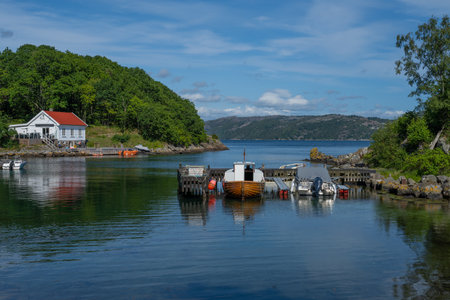 Lyngdal, Norway - July 06 2023: House and boats at Lundegaard