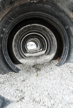 Looking through large used tires used in a playground