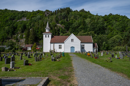Lyngdal, Norway - July 06 2023: view of Austad church and graveyardのeditorial素材