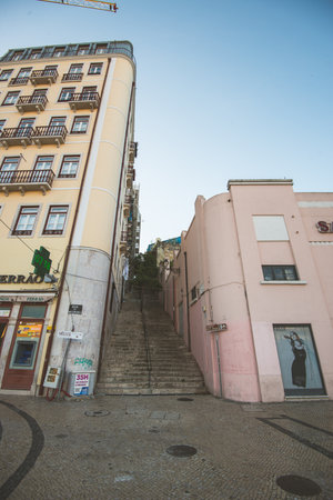 Lisbon, Portugal - July 21 2016: Stairs up a hill between two colourful apartment housesのeditorial素材