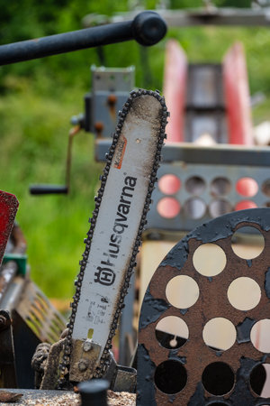 Lindesnes, Norway - June 21 2023: Husqvarna chainsaw blade on an automated wood cutterのeditorial素材