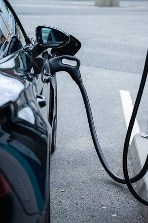 Handle of a DC charger attached to an electric carの写真素材