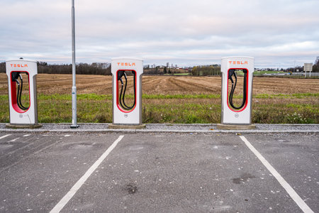 Oslo, Norway - november 19 2022: Three Tesla Superchargers by a fieldのeditorial素材