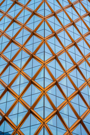 Corner facade of a glass and copper high rise building