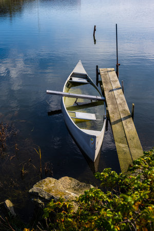 Sunken aluminium canoe in shallow waterの写真素材