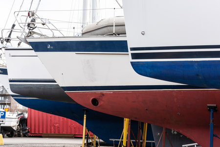 Gothenburg, Sweden - March 27 2022: Row of laid up sailboats longing for the spring.