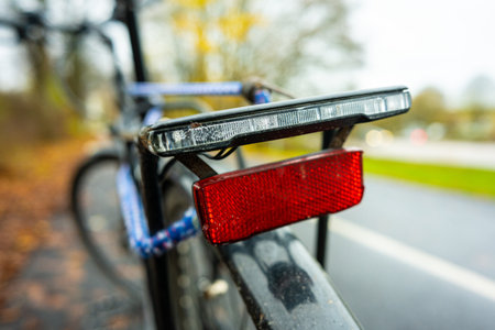 Reflex and rear lights of a black bicycleの写真素材