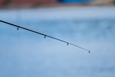Collapsible fishing rod against blue seaの写真素材
