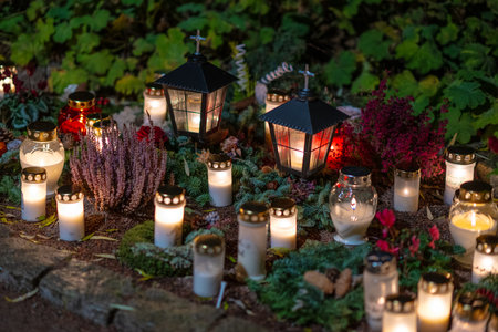 Grave candles on a cemetery on all saints eveの写真素材
