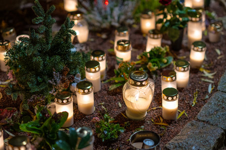 Grave candles on a cemetery on all saints eve