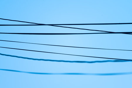Power lines hanging between poles