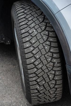 Studded winter tires on a wgite car