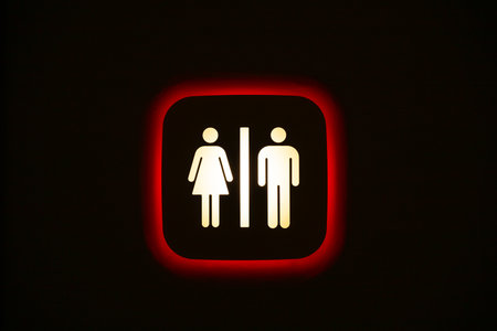 Unisex toilet sign on a black wall