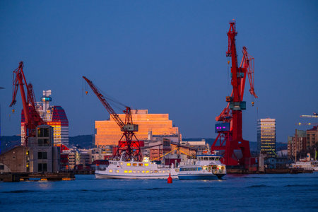 Gothenburg, Sweden - March 07 2024: Passenger ferries crossing the river in the eveningのeditorial素材