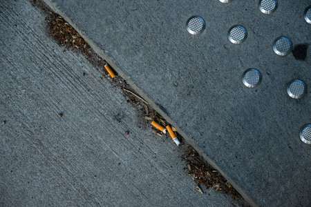 Cigarette buds littered on a pavement
