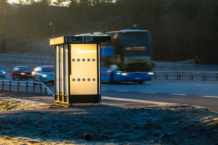 Gothenburg, Sweden - March 08 2024: Empty bus stop in golden sunrise lightのeditorial素材