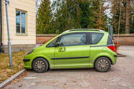 Uppsala, Sweden - March 10 2024: Green 2005 Peugeot 1007 small car at a parking lotのeditorial素材