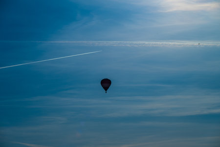 Hot air balloon rising on a sunny eveningの写真素材