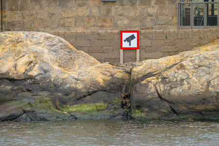Camera surveilance sign by the seaの写真素材