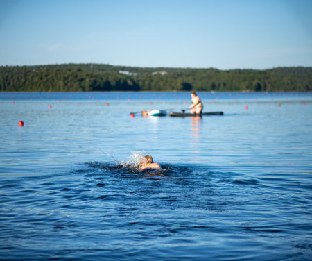 Person swimming in a lakeの写真素材