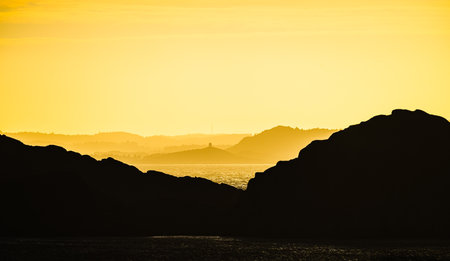 Sea haze in a rocky landscape at sunsetの写真素材