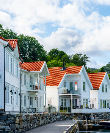 Row of white wooden houses by the seaの写真素材