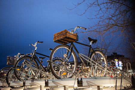 Uppsala, Sweden - March 09 2024: Night photo of bikes parked near a stationのeditorial素材