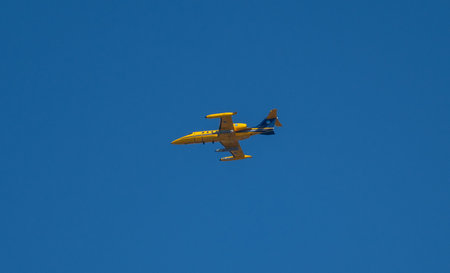 Varberg, Sweden - March 17 2024: Yellow Learjet 35 A SE-DHO training aircraft on a mission