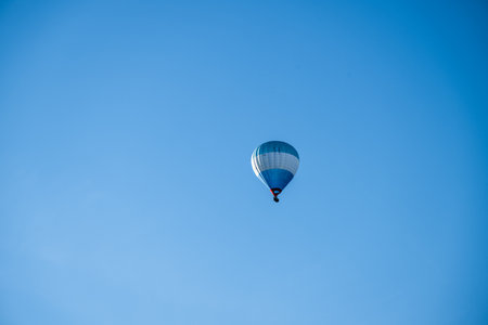 Blue white and red hot air balloon in evening sunの写真素材