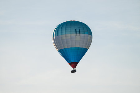 Blue white and red hot air balloon in evening sunの写真素材