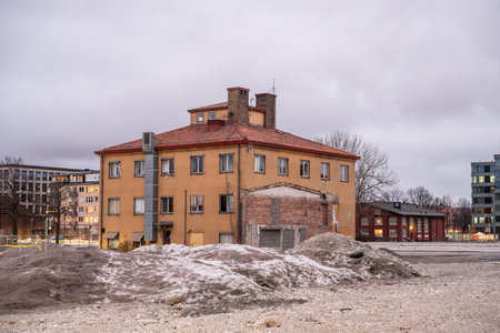 Uppsala, Sweden - March 09 2024: Lonely yellow brick building after other buildings have been demolishedのeditorial素材