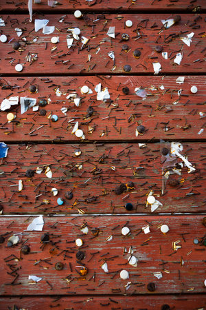 Staples and pins on a red notice boardの写真素材