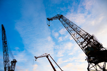 Looking up on old wharf cranesの写真素材