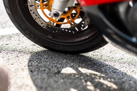 Front wheel of a fast red motorcycleの写真素材